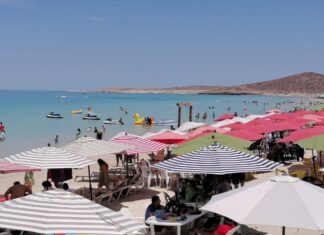People sunbathing under beach umbrellas on a Baja Caliornia Sur beach
