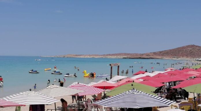People sunbathing under beach umbrellas on a Baja Caliornia Sur beach