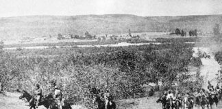 Black and white period photo of military men on horseback riding through the Baja California Peninsula
