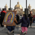 Pilgrims carrying an image of the virgen de guadalupe through the street
