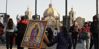 Pilgrims carrying an image of the virgen de guadalupe through the street