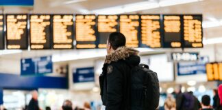 A man staring at airport departure boards.