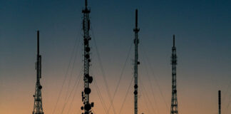 Telecommunication towers silhouetted at sunset