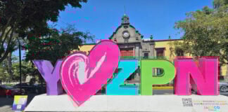 A large sign with the letters Y love ZPN in pink and purple. The sign is on a Square