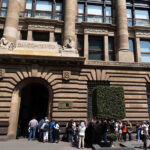 People line up outside the Bank of Mexico, an ornate art deco building