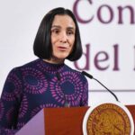 Luz Elena González speaking at podium