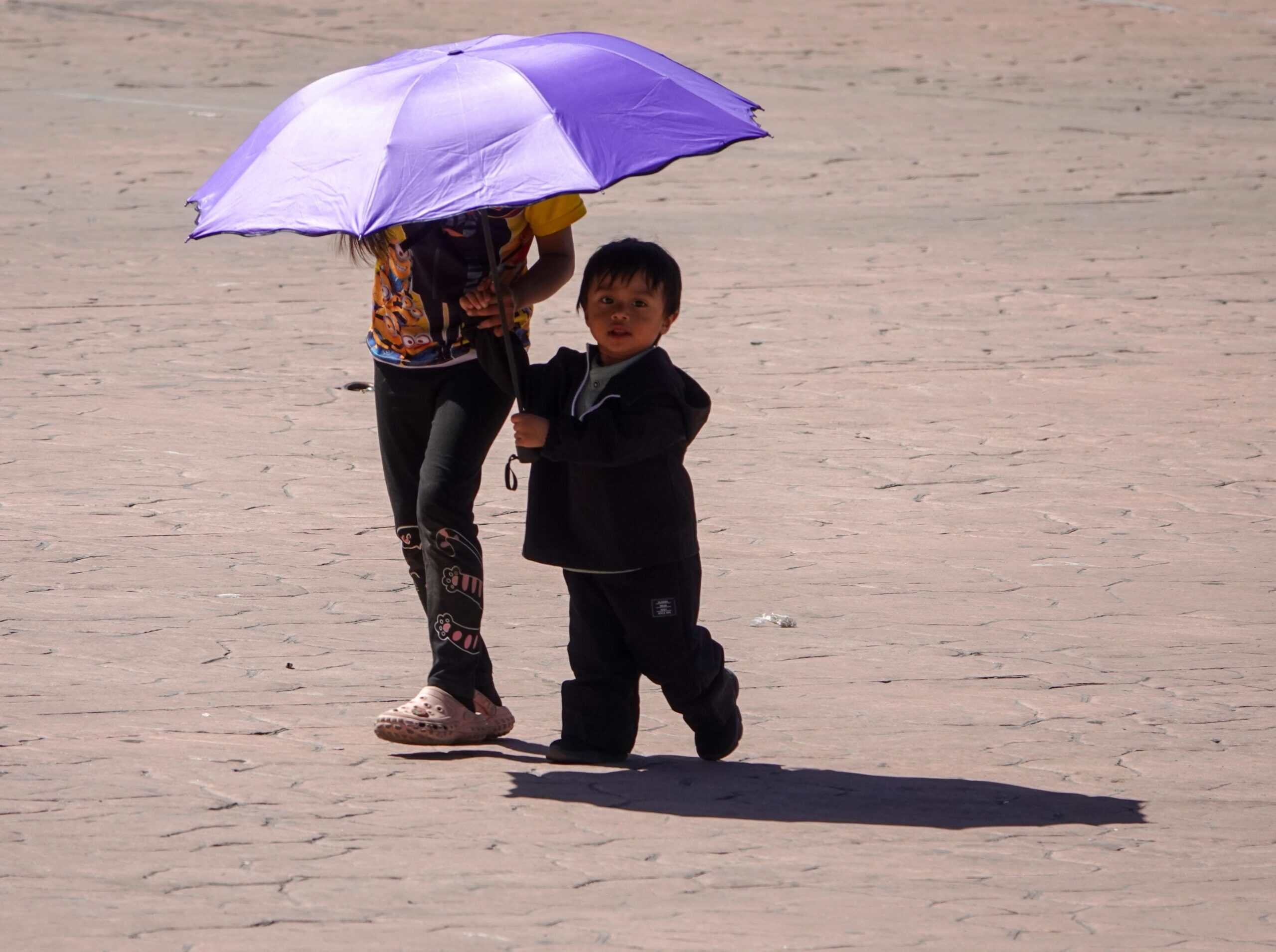 Mother and child protecting themselves from the sun
