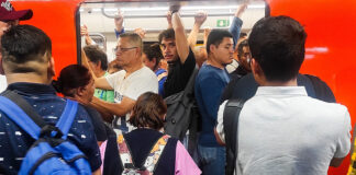 Riders pack into a metro car