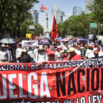 Teachers march down Reforma Avenue in Mexico City with a banner reading "Huelga Nacional"