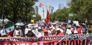 Teachers march down Reforma Avenue in Mexico City with a banner reading "Huelga Nacional"