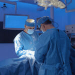 Two doctors perform a medical operation