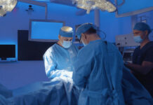 Two doctors perform a medical operation