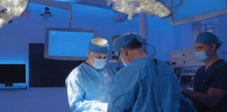 Two doctors perform a medical operation