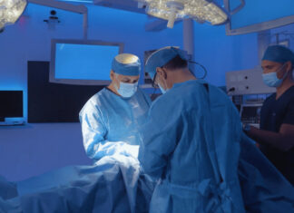 Two doctors perform a medical operation