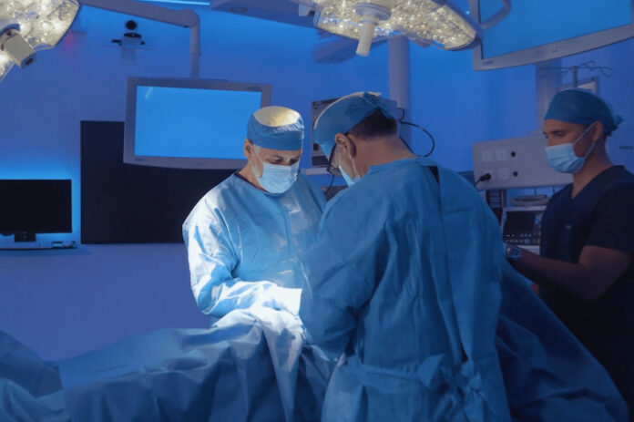 Two doctors perform a medical operation