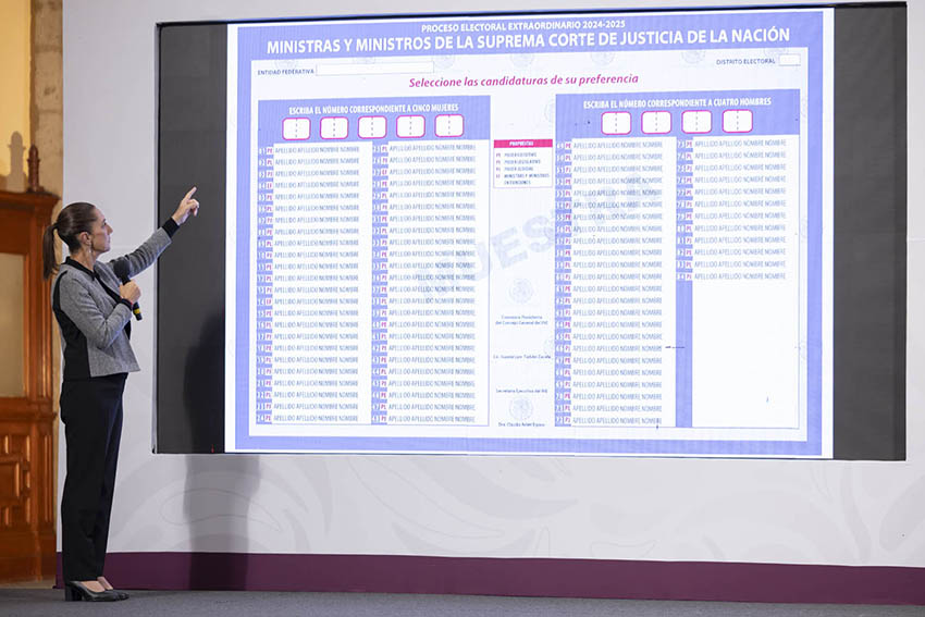 Sheinbaum points to a sample ballot projected on a large screen