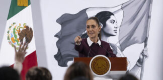 President Sheinbaum points to an audience of reporters at her morning press conference