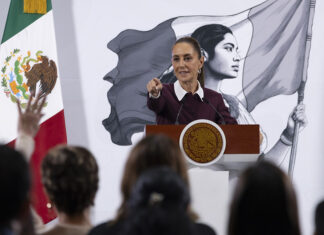 President Sheinbaum points to an audience of reporters at her morning press conference