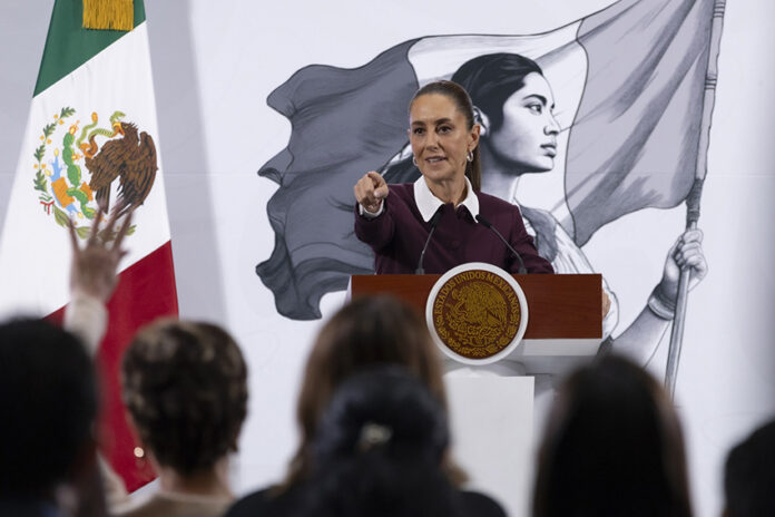 President Sheinbaum points to an audience of reporters at her morning press conference