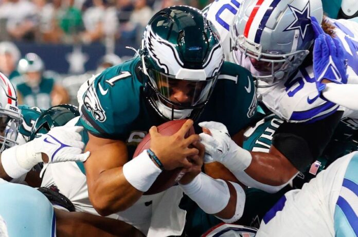 NFL players in a chaotic pile up.