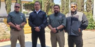 Victims Cesar Guzmán (R) and Carlos Amador (L) appeared in a photo last week with Jalisco Security Minister Juan Pablo Hernández (second to left)