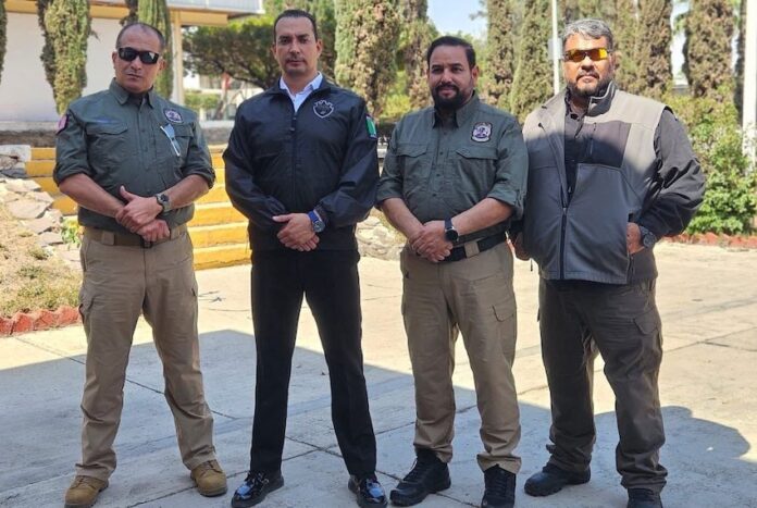 Victims Cesar Guzmán (R) and Carlos Amador (L) appeared in a photo last week with Jalisco Security Minister Juan Pablo Hernández (second to left)
