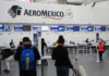 Passengers wait in line at an Aeromexico check in counter