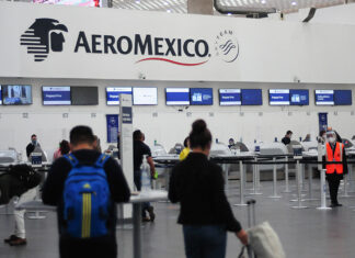 Passengers wait in line at an Aeromexico check in counter