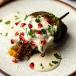 A chile en nogada served on a plate