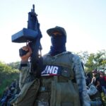 Masked member of CJNG with rifle