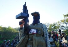 Masked member of CJNG with rifle