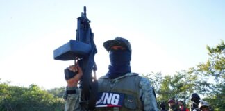 Masked member of CJNG with rifle