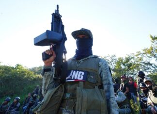 Masked member of CJNG with rifle