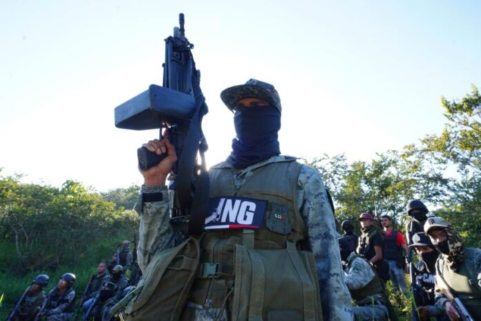 Masked member of CJNG with rifle
