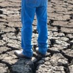 man's legs on dry ground