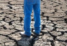 man's legs on dry ground