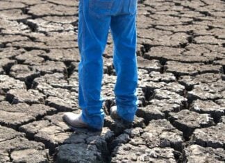 man's legs on dry ground