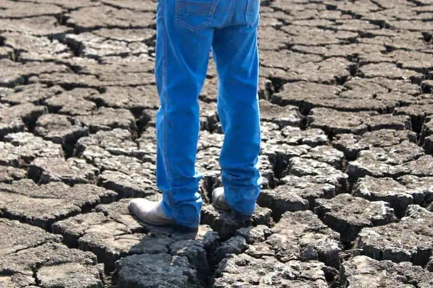 man's legs on dry ground