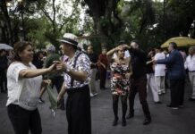 Pairs of middle-aged Mexican couples dancing in a public park in Mexico City.