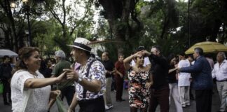 Pairs of middle-aged Mexican couples dancing in a public park in Mexico City.