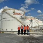 Persons in red standing in front of Bulkmatic facility