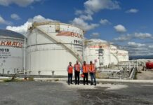 Persons in red standing in front of Bulkmatic facility