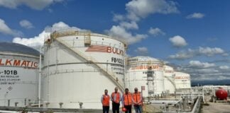 Persons in red standing in front of Bulkmatic facility