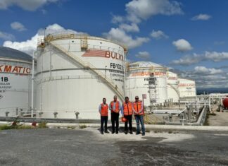 Persons in red standing in front of Bulkmatic facility
