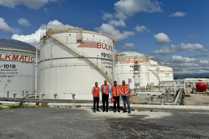 Persons in red standing in front of Bulkmatic facility