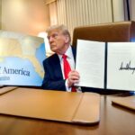 President Trump displays a recently signed bill renaming the Gulf of Mexico