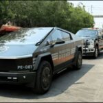 A parade of Jalisco security vehicles including a Tesla Cybertruck