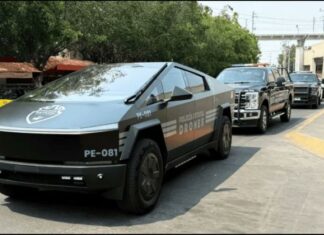 A parade of Jalisco security vehicles including a Tesla Cybertruck