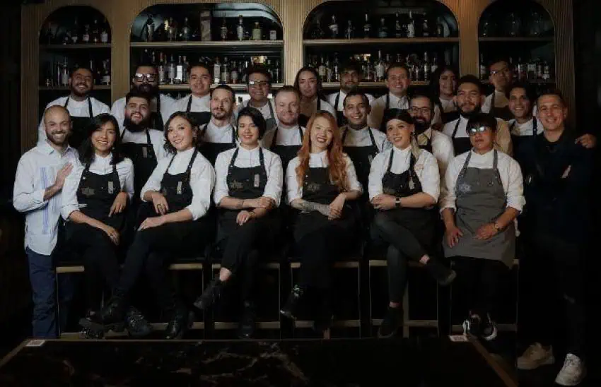 The staff at Handshake Speakeasy bar in Mexico City posed in uniform in three wide rows.