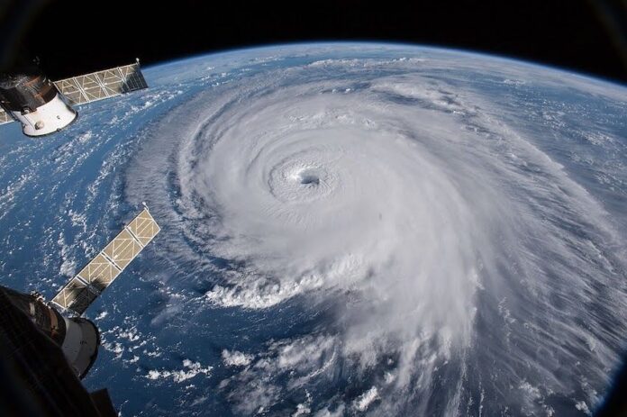 A hurricane with its eye on Earth, seen from outer space.